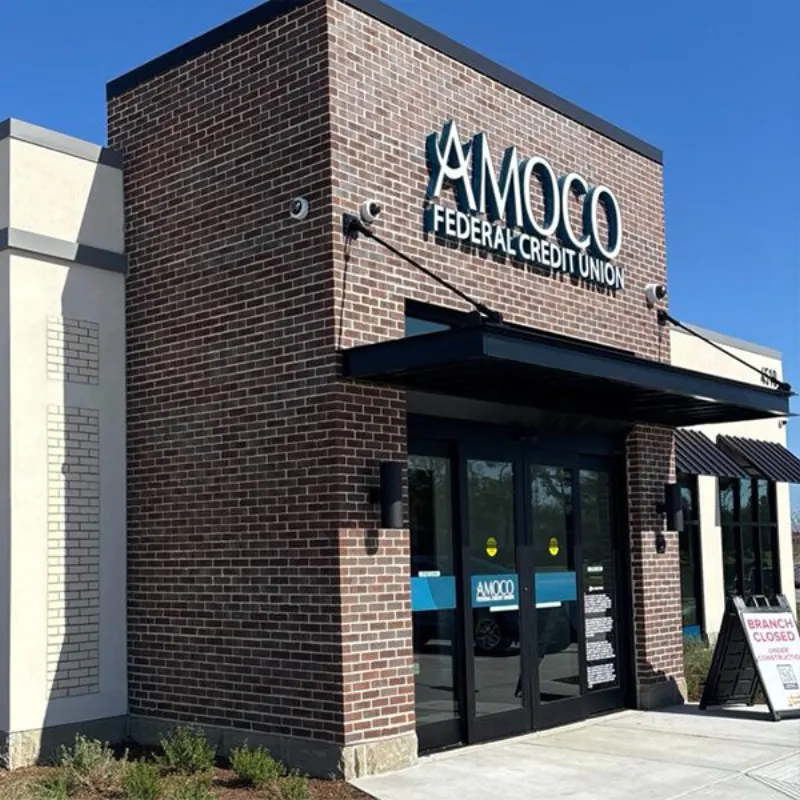 Amoco Federal Credit Union branch with a brick facade and glass entry