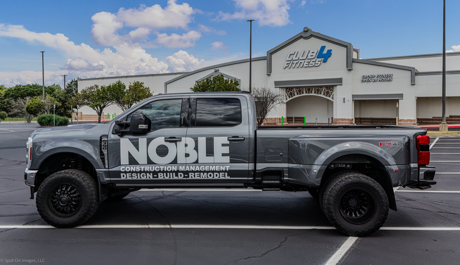 Noble Construction Management truck parked outside the completed CLUB4 Fitness in Bryan, Texas